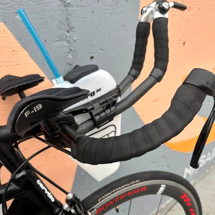 Close-up of a Cervelo Dual bicycle front aerobar and hydration bottle